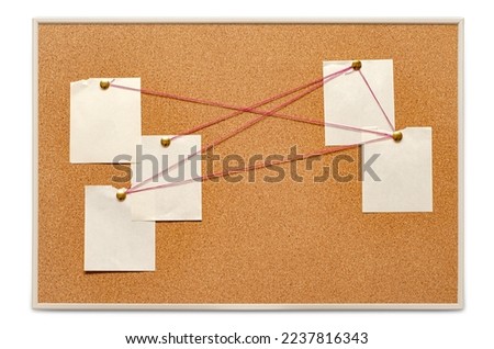 Blank paper notes are pinned to a cork board. The concept of detective investigation. Copy space. Royalty-Free Stock Photo #2237816343