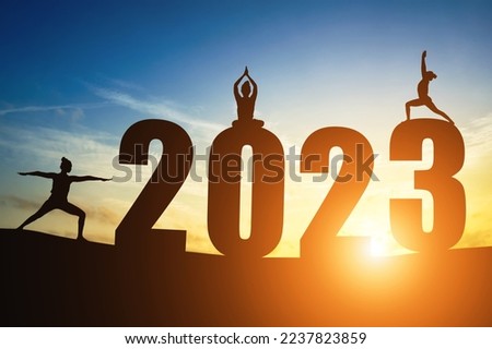 Happy New Year Numbers 2023, Silhouette woman practicing yoga early morning sunrise over the horizon background, Health and Happy new year concept.