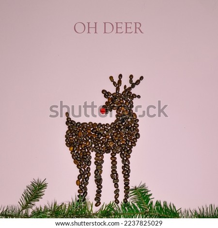 Christmas composition. Reindeer made of coffee beans and red ornament as nose with pine tree branches against pink background. Flat lay, top view, copy space. New Year sale card. Coffee lovers.Oh deer