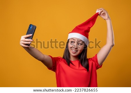 Cute young asian woman making selfie and making pose