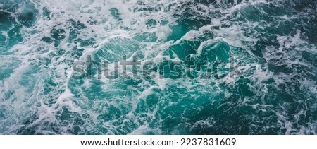 Sea foamy waves close up, abstract nature background and texture
