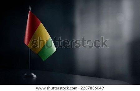 Small national flag of the Guinea on a black background.
