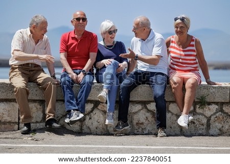 group of elderly friends discuss and have fun near a marina Royalty-Free Stock Photo #2237840051