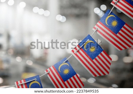 A garland of Malaysia national flags on an abstract blurred background