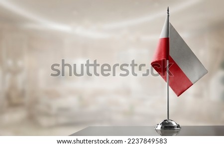 A small Poland flag on an abstract blurry background Royalty-Free Stock Photo #2237849583