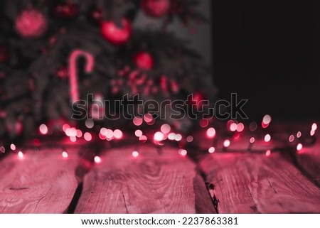 background image. wallpapers on the desktop in the New Year style. Wooden photo background with garlands and bokeh on black. A fresh classic for 2023 in Viva Magenta. Color concept of the year