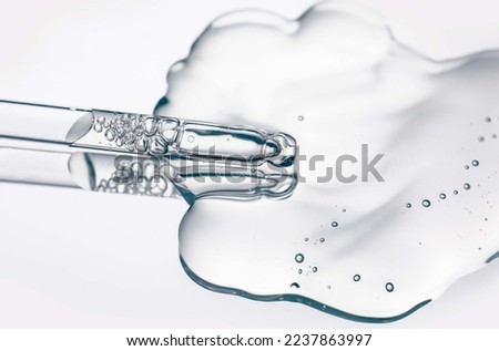 Cosmetic serum texture with dropper transparent liquid background Royalty-Free Stock Photo #2237863997