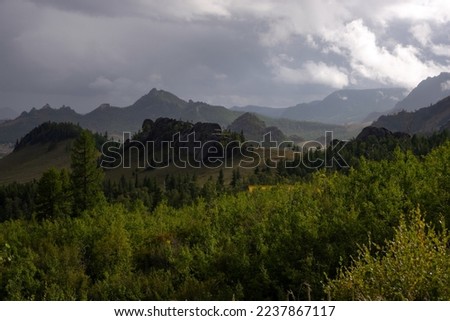 Terelj national park landscape, mountain ridge in Mongolia. Overview of the valley with the dramatic sky in the background.