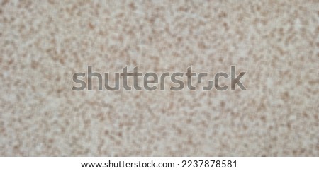 Defocused or blurred textured dotted paint on a white beige background.