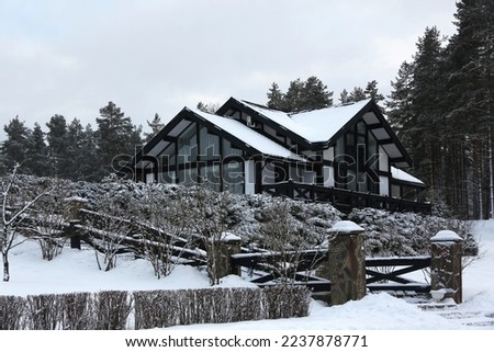 Cottage in winter landscape, horizontal picture