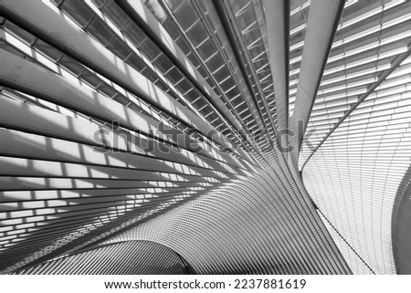 Steel and glass structures of with sun illuminating and enhancing light and shadow. Black and white greyscale graphic background with lines, diagonals and curves. Royalty-Free Stock Photo #2237881619