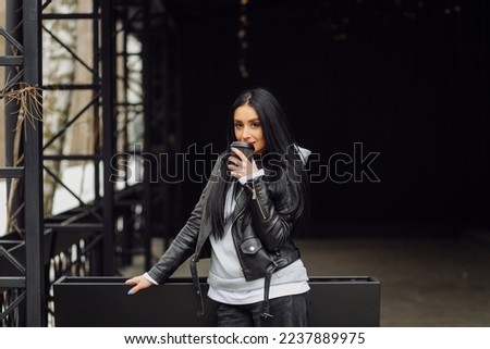 Young caucasian girl with dark long hair in sporty gray hoodie
