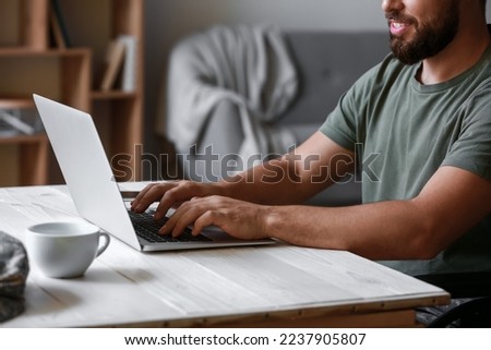 Soldier in wheelchair using laptop at home, closeup