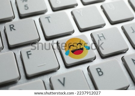 Laughing emoticon on PC keyboard, closeup Royalty-Free Stock Photo #2237912027