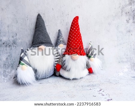 Christmas Dwarfs with Red and Gray Caps on Gray Textured Background 