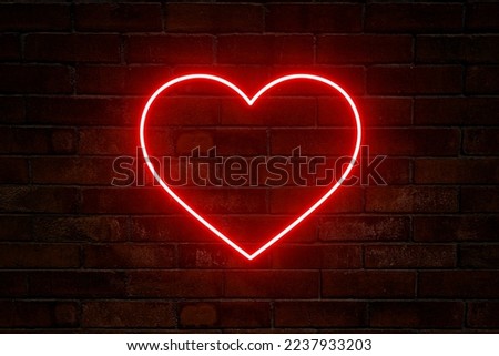 Neon heart with a glow on the background of a dark brick wall. Neon sign. Royalty-Free Stock Photo #2237933203
