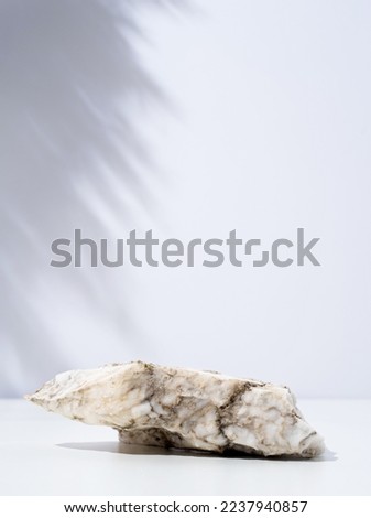 A minimalistic scene of stone marble podium on white background, for natural cosmetics. Showcase with a stage for products, mockup design