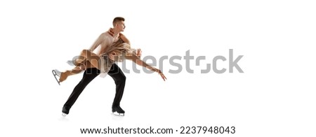 Support. Portrait of young man and woman, figure skating athletes performing, training isolated over white studio background. Concept of movement, sport, beauty, hobby, competition. Ad, flyer
