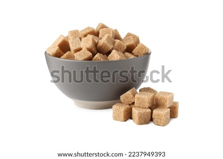 Bowl and brown sugar cubes on white background Royalty-Free Stock Photo #2237949393