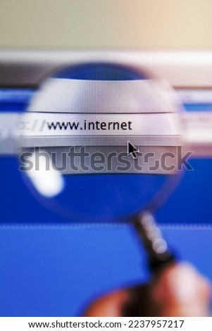 Magnifying glass on top of search icon of computer screen Royalty-Free Stock Photo #2237957217