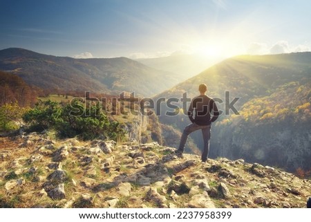 Man in mountain and sun shine. Nature and people.
