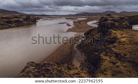 Panoramic view of the Landmannalaugar volcanic mountains, and flooding by a river in Iceland, summer, wide angle.