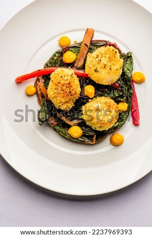 Scallops. Scallops sautéed in olive oil, with crushed almonds, garnished with scallions, parsley and served with organic vegetables. Classic Italian, American restaurant or French bistro entree. Royalty-Free Stock Photo #2237969393