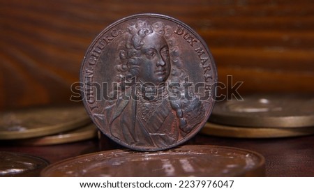 Old commemorative medal John Churchill, 1st Duke of Marlborough on the background of antique medals european aristocracy selective focus