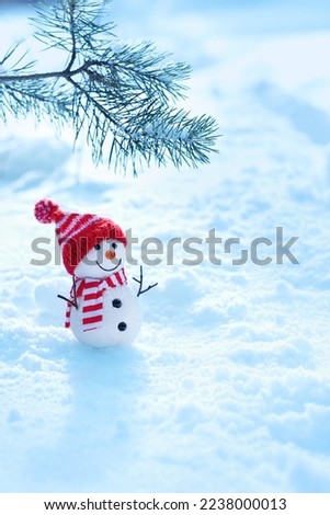Christmas background. cute snowman toy and pine tree branch in snow. New Year and Christmas holidays. festive winter season. copy space. template for design