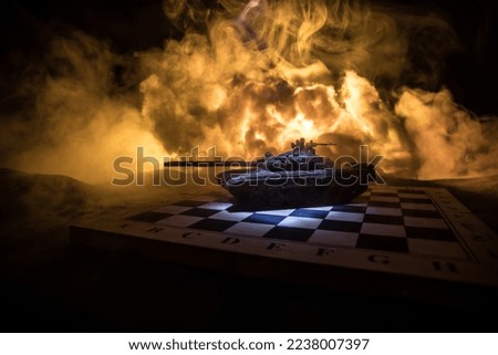 War between Russia and Ukraine, conceptual image of war using chess board and tank on a dark background of explosion. Ukrainian and Russian crisis, political conflict. Selective focus