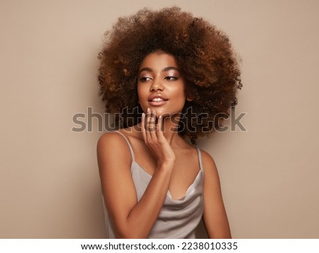 Beauty portrait of African American girl with afro hair. Beautiful black woman. Cosmetics, makeup and fashion Royalty-Free Stock Photo #2238010335