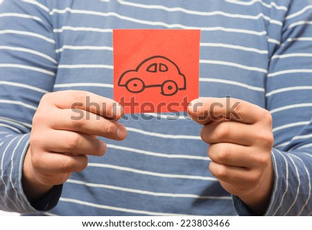 drawing a picture in his hand car