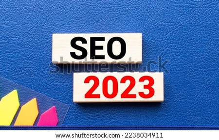 SEO 2023. text on a notebook and on wooden blocks