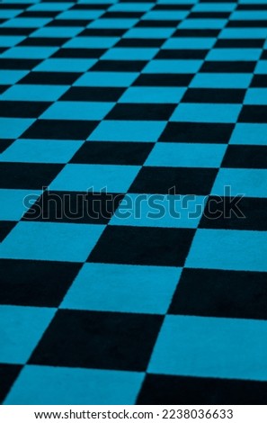 Black and blue checkered carpet at an angle.