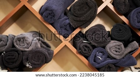Wardrobe with clean towels in the spa beauty salon. towels in rolls lie on the shelves. towels in rolls lie on the shelves in the beauty salon.
