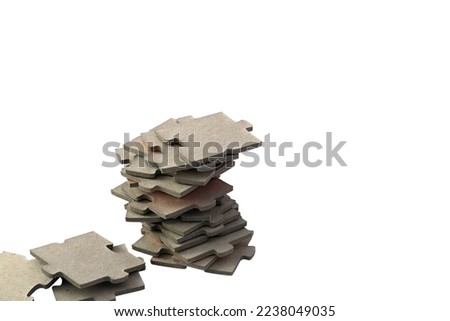One pile of gray puzzle pieces. Close up and isolated on a white background.