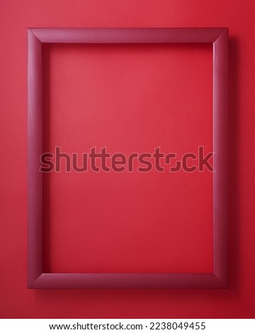 Red wooden picture frame on red background
