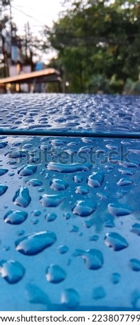 water droplets on the hood of the car with an aesthetic texture in the morning