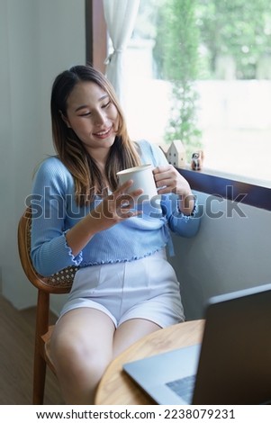 business woman sitting and drinking coffee and smiling happily.