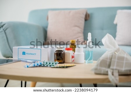 Home medicine with medicine package box free first aid kit with pills from pharmacy hospital delivery service at home on table in living room, online purchase delivery of medicines to your home Royalty-Free Stock Photo #2238094179