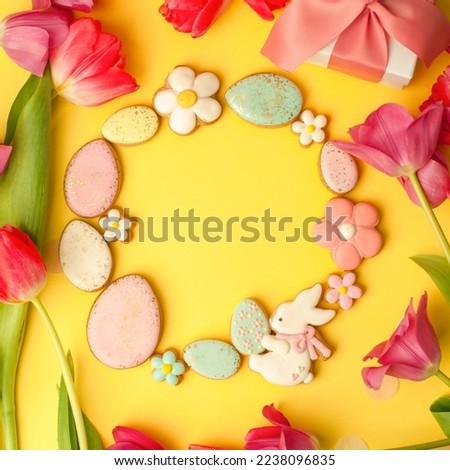 Easter floral food wreath, various gingerbread glazed cookies end decorated with natural botanical elements on yellow, flat lay, view from above, blank space for greeting text, banner, flyer, coupon