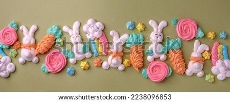 Colorful easter Sweet cookies, meringue on green background, colorful seasonal holiday concept, stylish greeting card, invitation, flyer. Delicious traditional snack cookies for kids, copy space