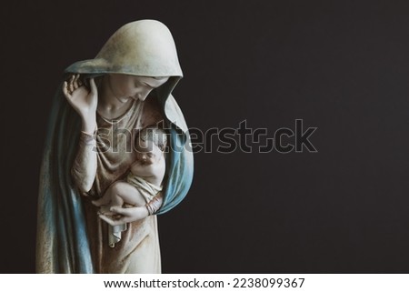 Statue of Virgin Mary holding baby Jesus with a black background with copy space  Royalty-Free Stock Photo #2238099367