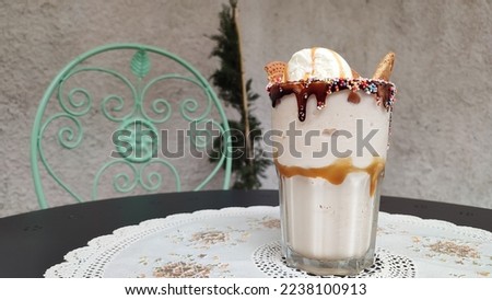 Biscuits caramel vanilla milkshake with ice cream on a dinning table