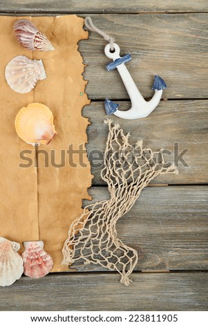 Decor of seashells, starfish and old paper on wooden table background
