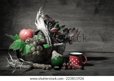Picturesque autumn composition with  basket, fruits, pumpkin, mugs and cartridge