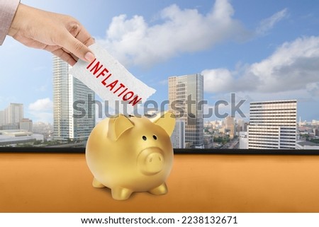 Businessman hand holding a paper with inflation sign with cityscape background