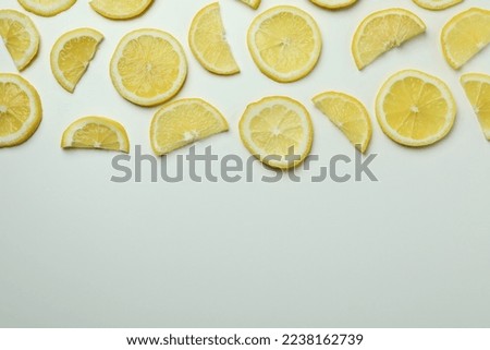 Ripe lemon slices on white background, space for text