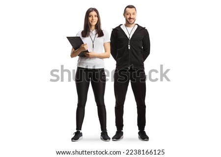 Full length portrait of a female and male sport coaches isolated on white background