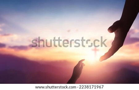 Religion and salvation concept:God reaching out to help people on cross background Royalty-Free Stock Photo #2238171967